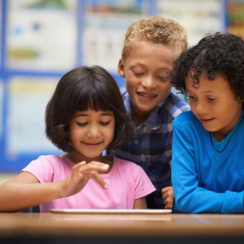 tabletassisted-learning-three-school-students-working-digital-tablet-class (1)